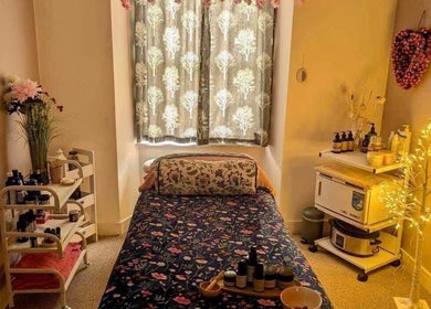 Cozy therapy room at Heavenly Treatments with Hayleybell, Kelso, Scotland, GB with soft lighting and floral decor.