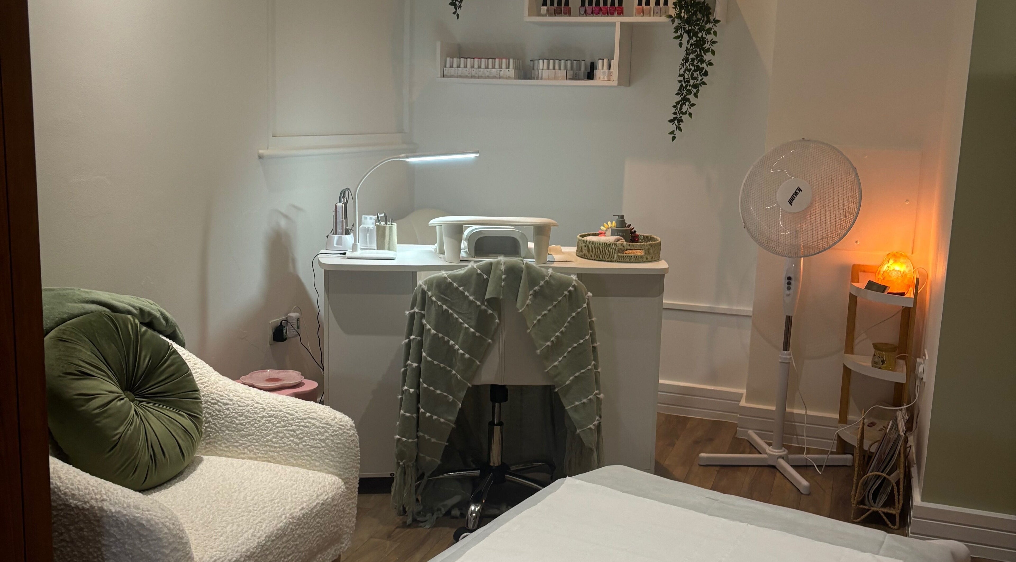 Mani’s by Millie May in Bridgend, Wales, GB offers a cozy beauty space with plush seating and a nail station.