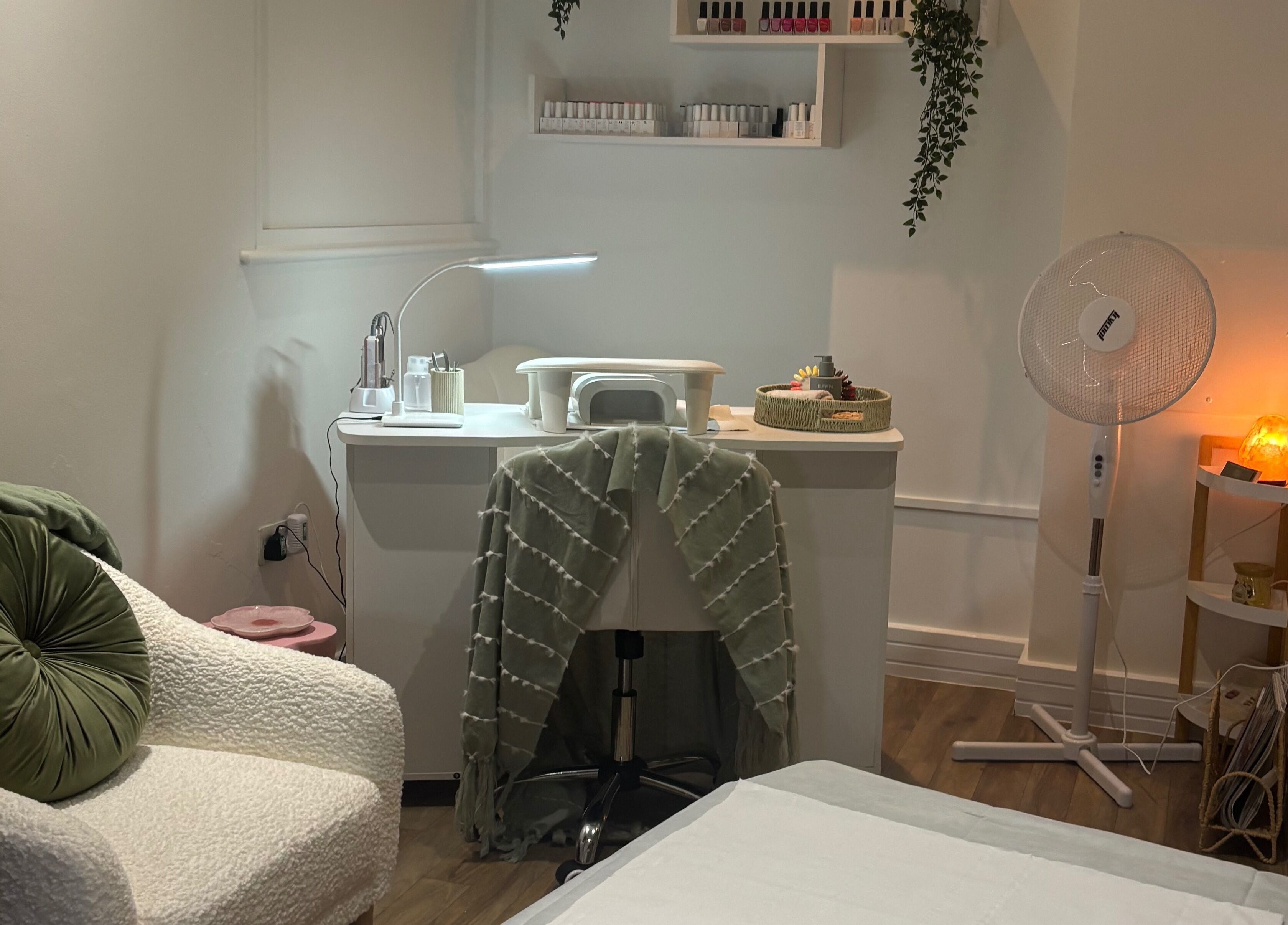 Nail care station at Mani’s by Millie May, Bridgend, Wales, GB, featuring a comfy chair and ambient lighting.