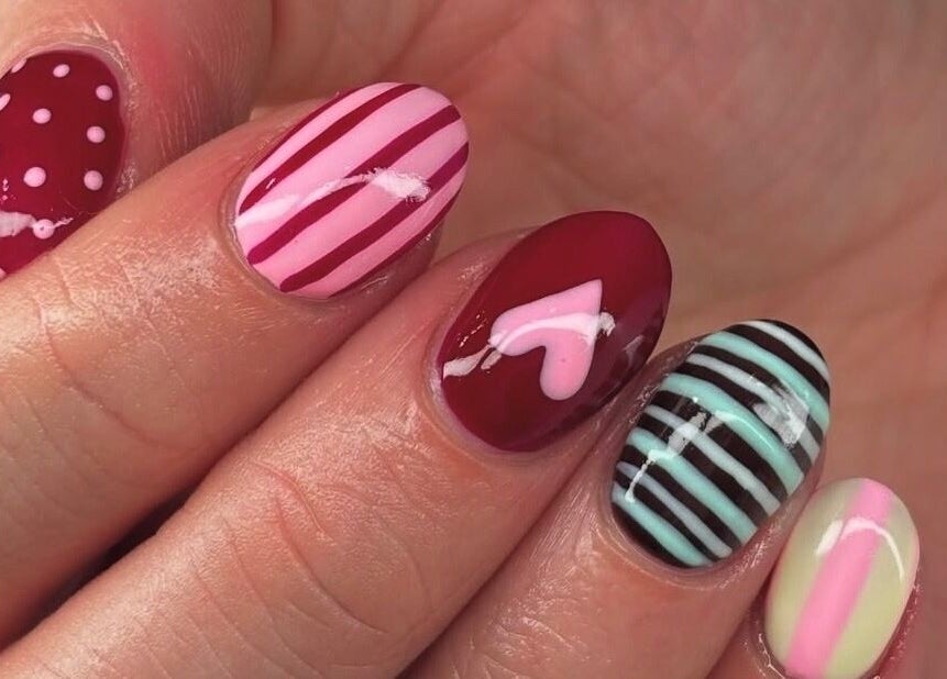 Colorful nail art at Mani’s by Millie May, Bridgend, Wales, GB, showcasing stripes and dots.
