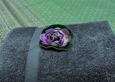 Afon Thai Massage in Cardiff, Wales, GB: elegant purple flower on gray towel.