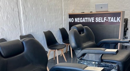 Interior of Freshmen Cutz Barbershop in Midrand, Gauteng, ZA, featuring sleek black barber chairs and modern decor.