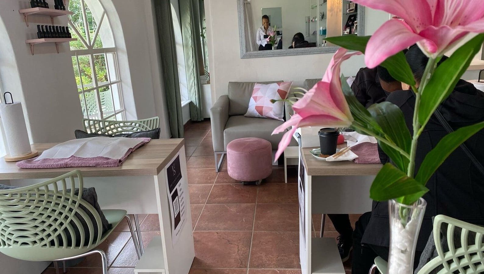 Cozy lounge at The Vanity Suite, Pretoria, Gauteng, ZA with pink decor and bright windows.