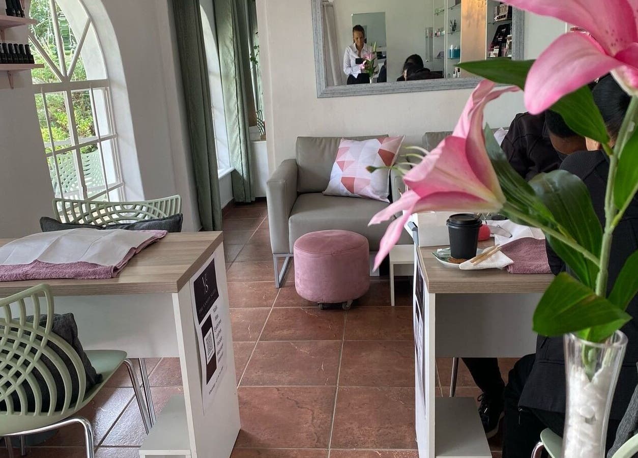 Cozy lounge at The Vanity Suite, Pretoria, Gauteng, ZA with pink decor and bright windows.