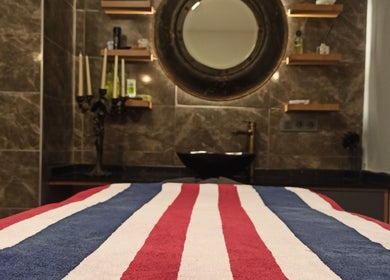 Luxurious spa room at Fey Massage And Spa, İstanbul, İstanbul, TR with a striped massage table.