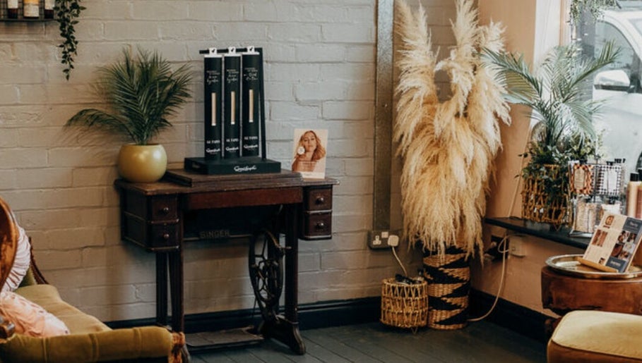 Cozy corner at House of Swain HAIR & EXTENSION SALON, Whitehaven, England, GB with vintage decor and plants.