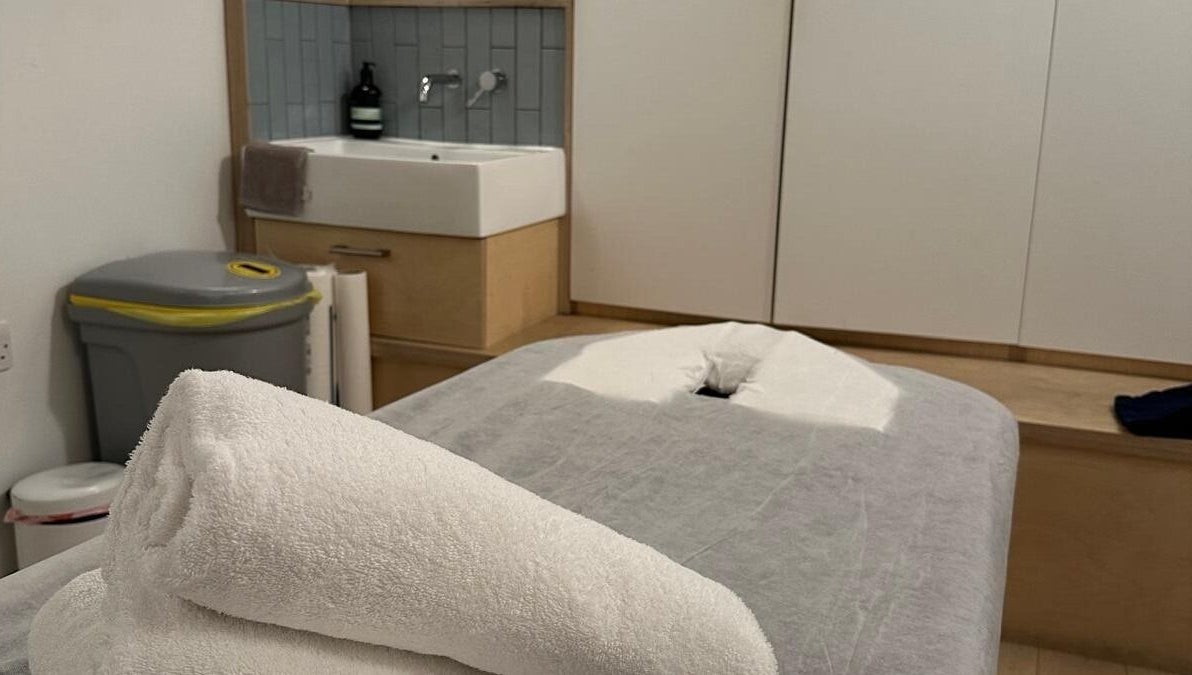 Massage table with fresh towels at JM Massage Therapy, London, England, GB offering relaxation and comfort.
