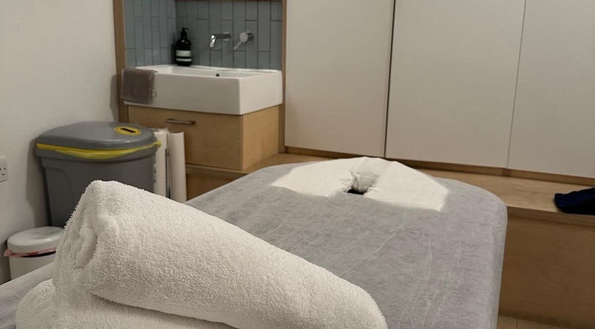 Massage table with fresh towels at JM Massage Therapy, London, England, GB offering relaxation and comfort.