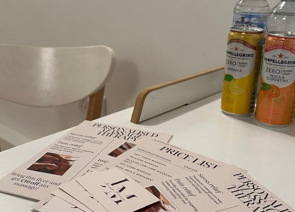 JM Massage Therapy flyers and drinks on a table in London, England, GB offer a relaxing at-home service overview.
