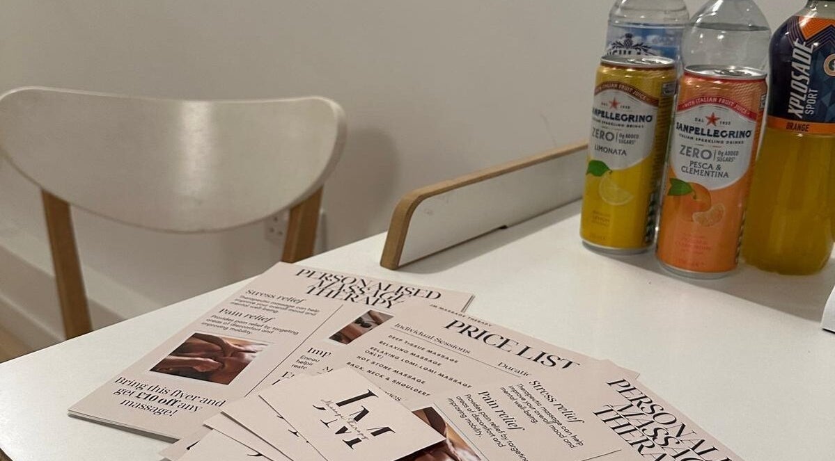 JM Massage Therapy flyers and drinks on a table in London, England, GB offer a relaxing at-home service overview.