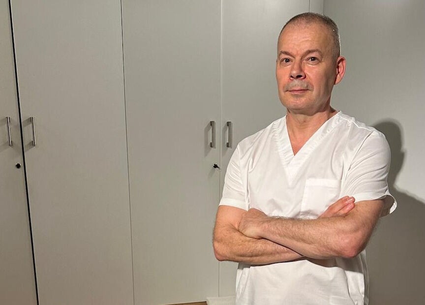 Professional therapist at JM Massage Therapy, London, England, GB, in a serene treatment room.