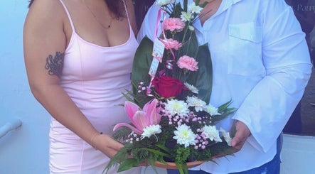 Floral arrangement at S.S. Beauty Loft, Paramaribo showcasing lush blooms and greenery.