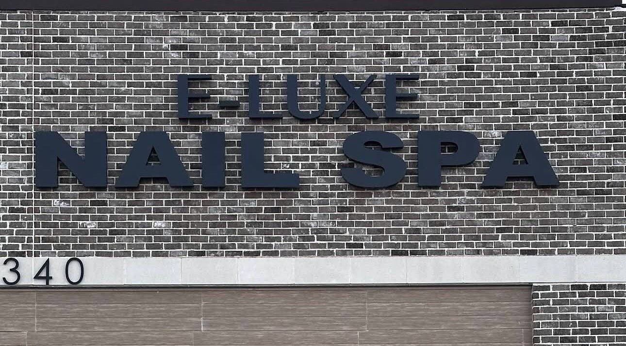 Q @ E-Luxe Nail Spa signage on brick exterior in League City, Texas, US.