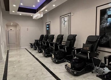 Sleek pedicure chairs at Q @ E-Luxe Nail Spa, League City, Texas. Relaxing ambiance with modern decor.