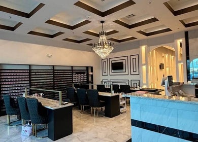Elegant interior of Q @ E-Luxe Nail Spa in League City, Texas, US, featuring luxurious seating and chandelier lighting.