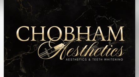 Chobham Aesthetics logo with syringe motif in Chobham, England, GB on dark marble background.