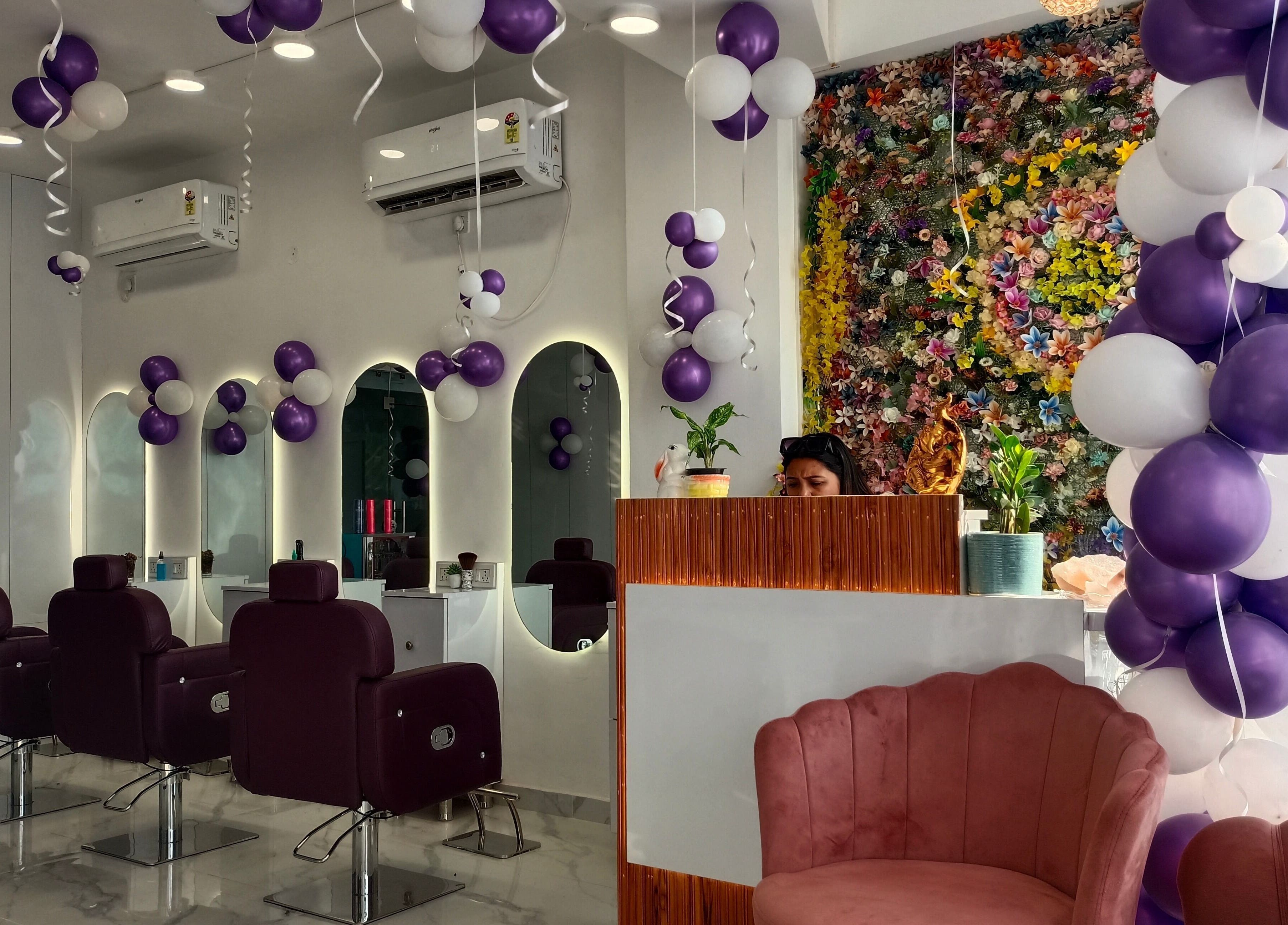 Interior of Belles & Beaus salon in Dehradun, Uttarakhand, IN with purple decor and mirrors.