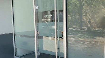 Entrance of Brand Nail Studio showcasing modern glass doors in Philadelphia, Pennsylvania, US.