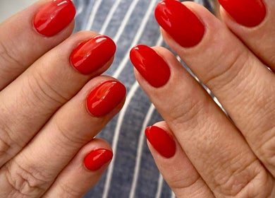 Vibrant red manicure at Purple Nail in Montgomery, Texas, US, showcasing stylish nail art.
