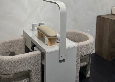 Modern nail care station at Beauté De Mart in Glendale, California, US, featuring plush seating and sleek design.