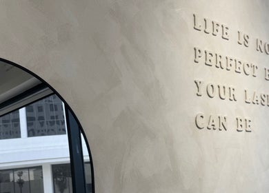 Inspirational wall quote at Beauté De Mart, Glendale, California, US, highlighting perfect lashes.
