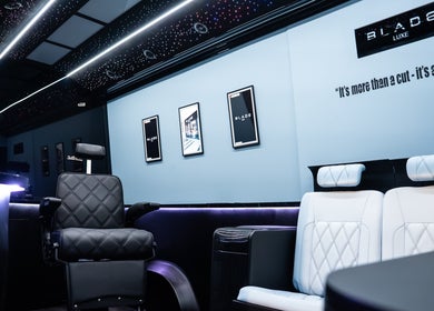 Elegant interior of Blade Luxe, a premium barbershop in Abu Dhabi, UAE, showcasing luxury seating and decor.