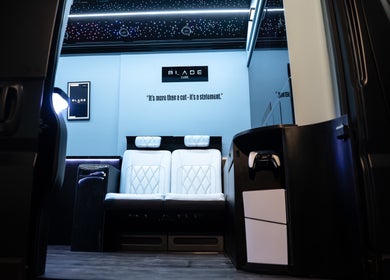 Elegant interior of Blade Luxe salon in Abu Dhabi, AE, featuring plush seating under a starlit ceiling.