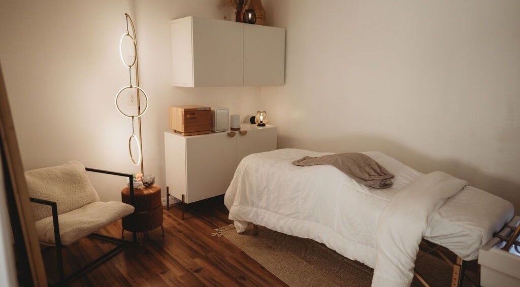 Cozy spa room at Luxe Beauty Head Spa, Lutz, Florida. Features massage bed and warm lighting.