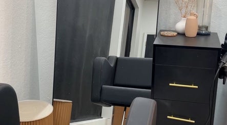 Modern salon corner at Luxe West Collective in Lutz, Florida, US with a mirror, chair, and stylish decor.