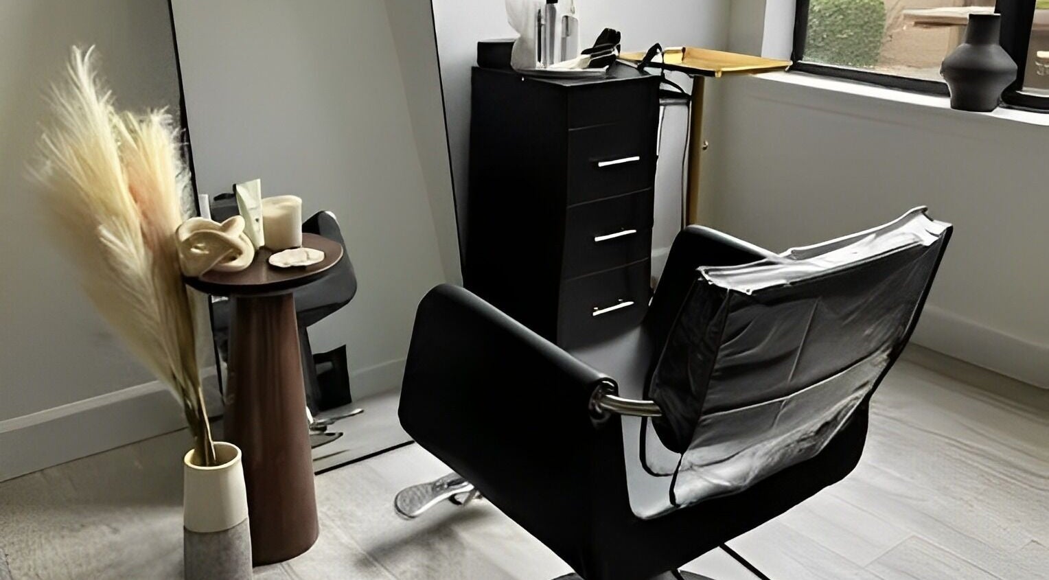 Elegant beauty station at Luxe West Collective, Lutz, Florida, US featuring a sleek chair and mirror.