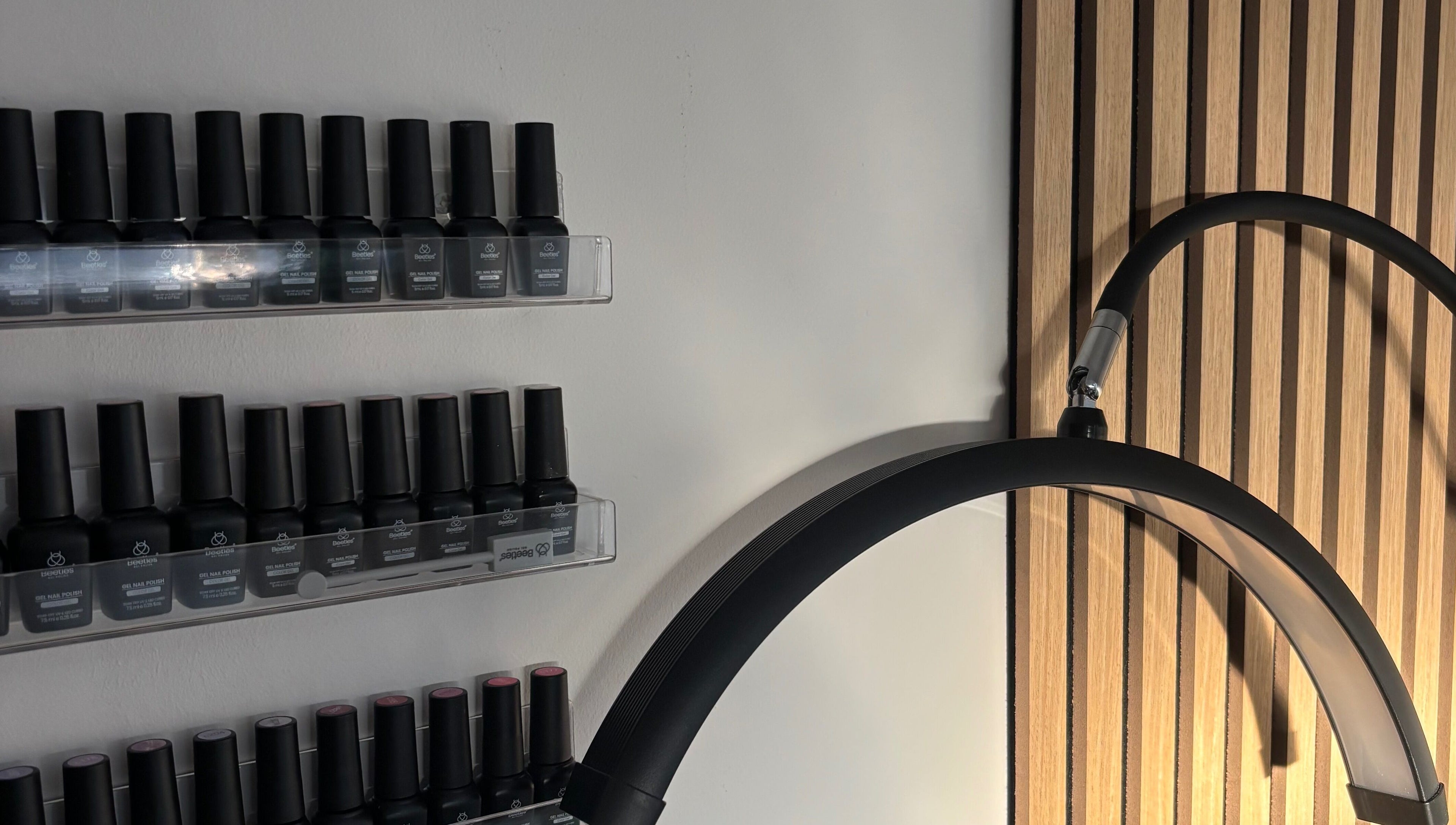 Nail polish display at Elegancewithellie, Walton, England, GB, featuring sleek shelves and modern design.