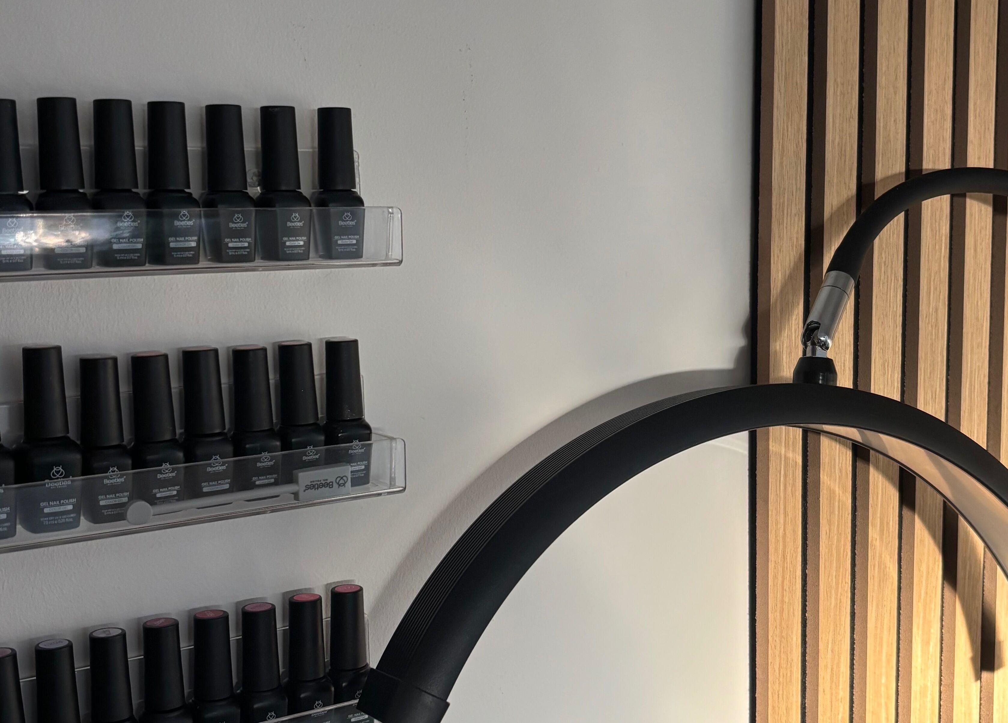 Nail polish display at Elegancewithellie, Walton, England, GB, featuring sleek shelves and modern design.