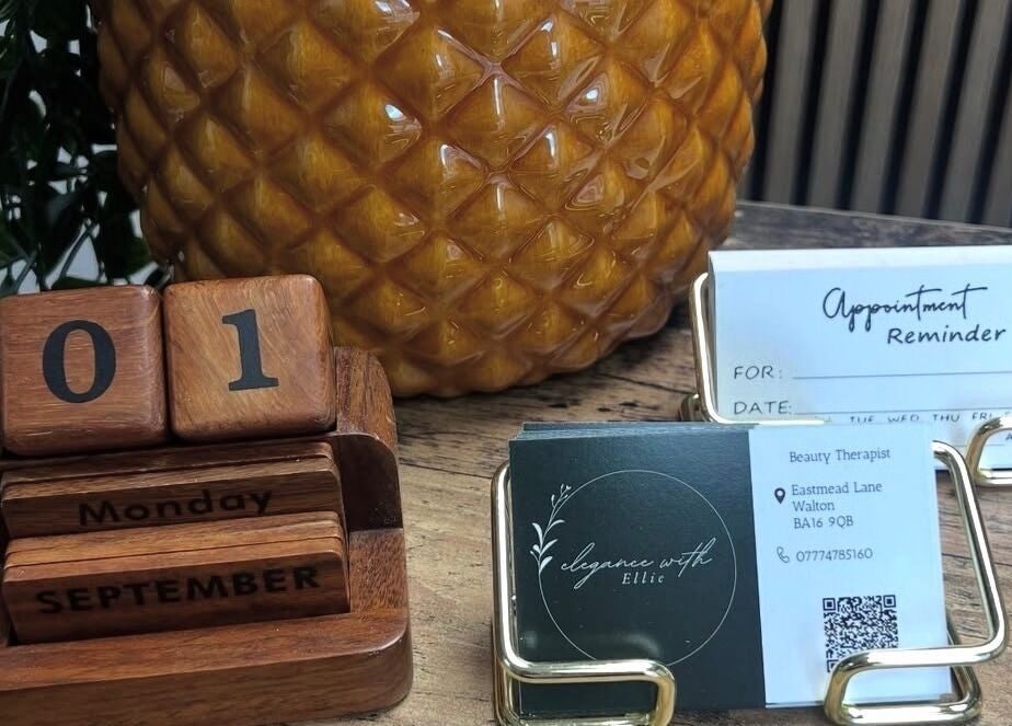 Elegancewithellie Walton display with calendar and appointment cards on rustic desk.