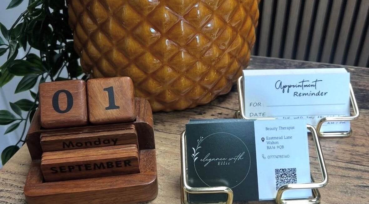 Elegancewithellie Walton display with calendar and appointment cards on rustic desk.