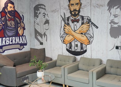 Stylish waiting area with barber-themed murals at Perfect Image Gents Salon, Sharjah, Sharjah, AE.