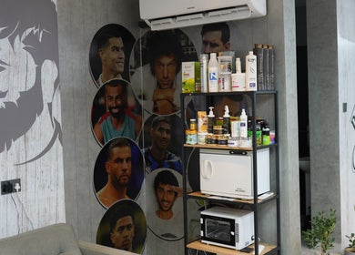 Interior of Perfect Image Gents Salon in Sharjah, AE, featuring male celebrity portraits and grooming products.