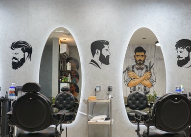 Interior of Perfect Image Gents Salon in Sharjah, AE, showcasing modern barber chairs and wall art.