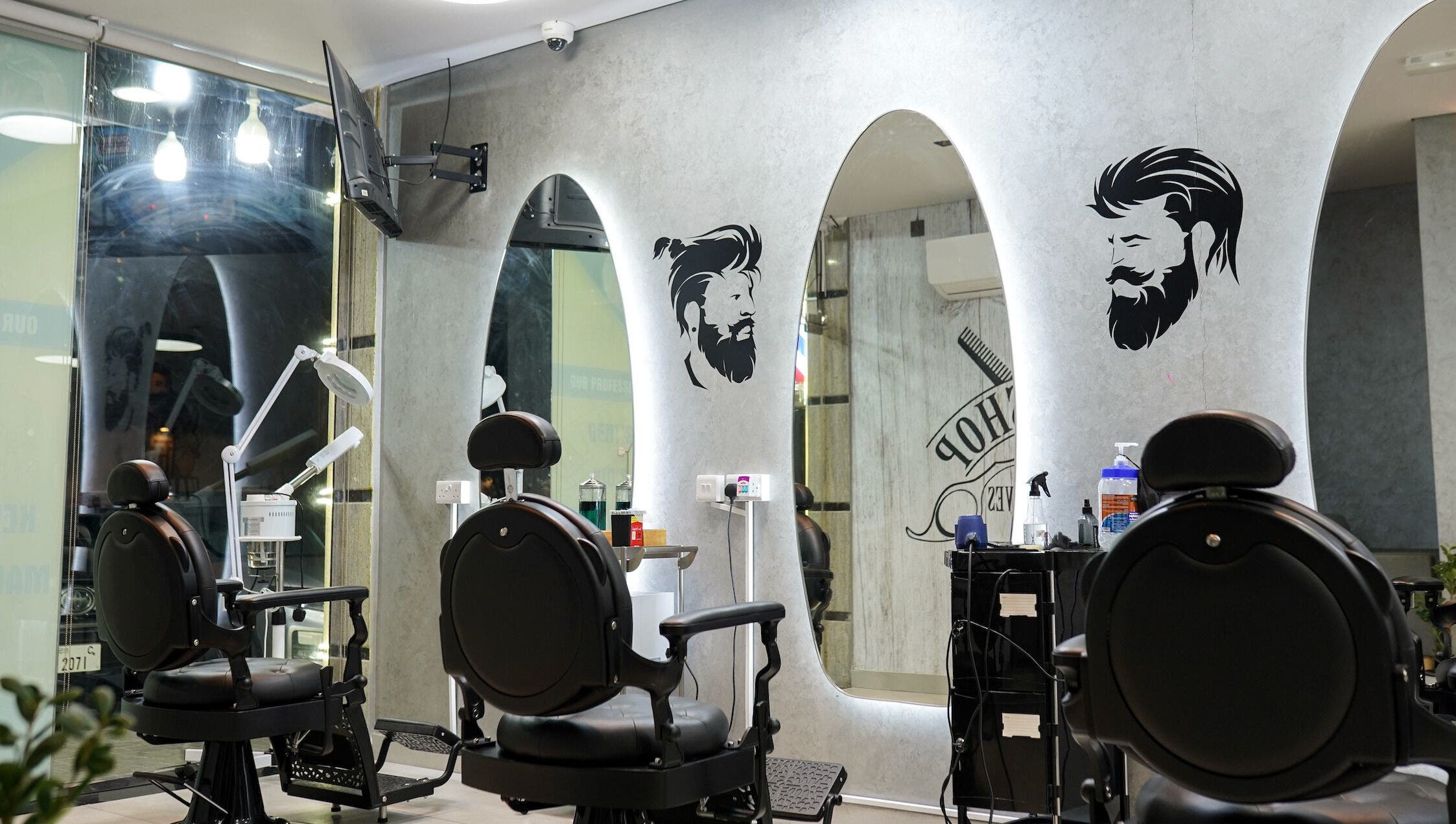Stylish interior of Perfect Image Gents Salon in Sharjah, AE, featuring modern barber chairs and mirrors.