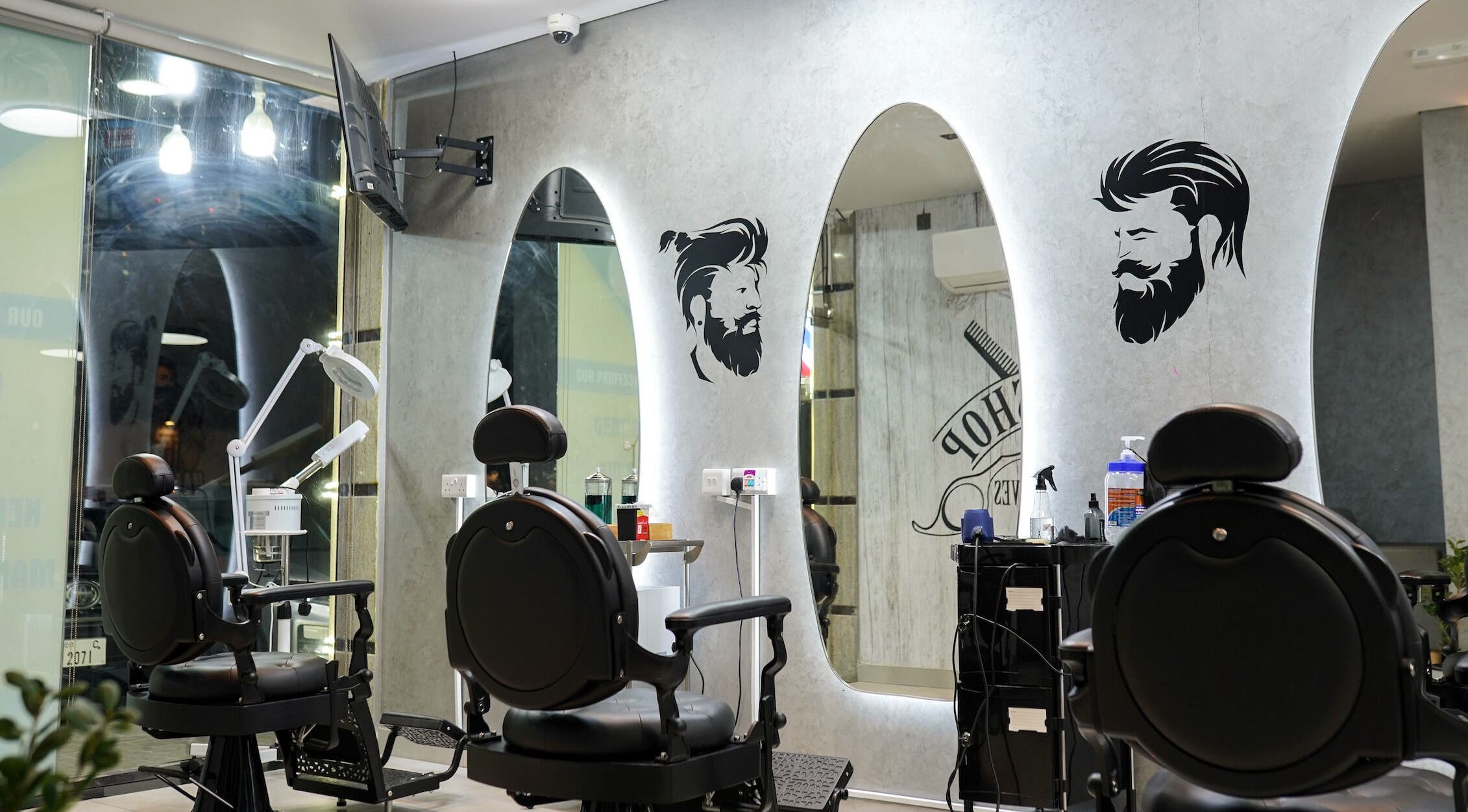 Stylish interior of Perfect Image Gents Salon in Sharjah, AE, featuring modern barber chairs and mirrors.