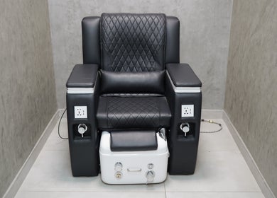 Luxury pedicure chair at Perfect Image Gents Salon, Sharjah, Sharjah, AE with black leather upholstery.
