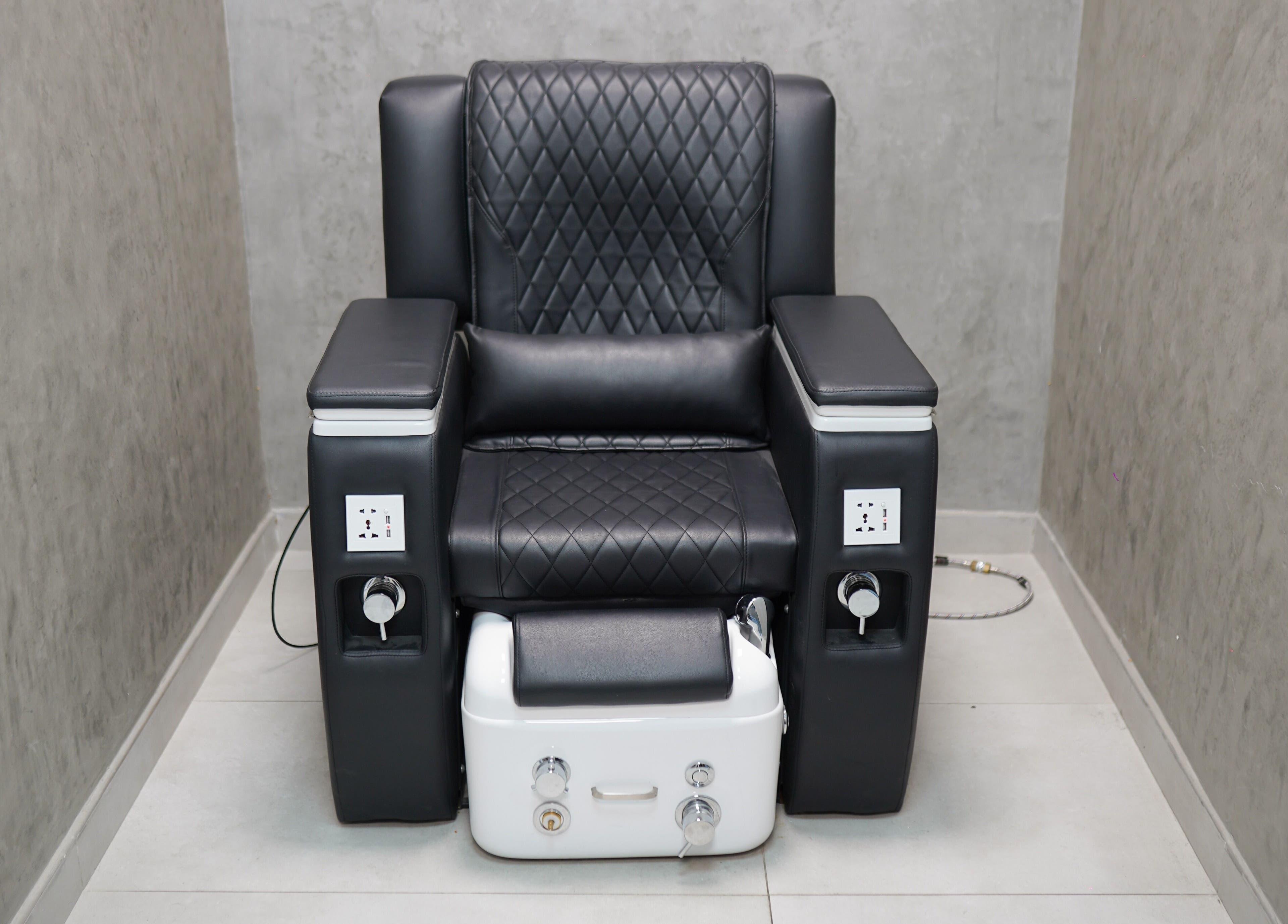 Luxury pedicure chair at Perfect Image Gents Salon, Sharjah, Sharjah, AE with black leather upholstery.