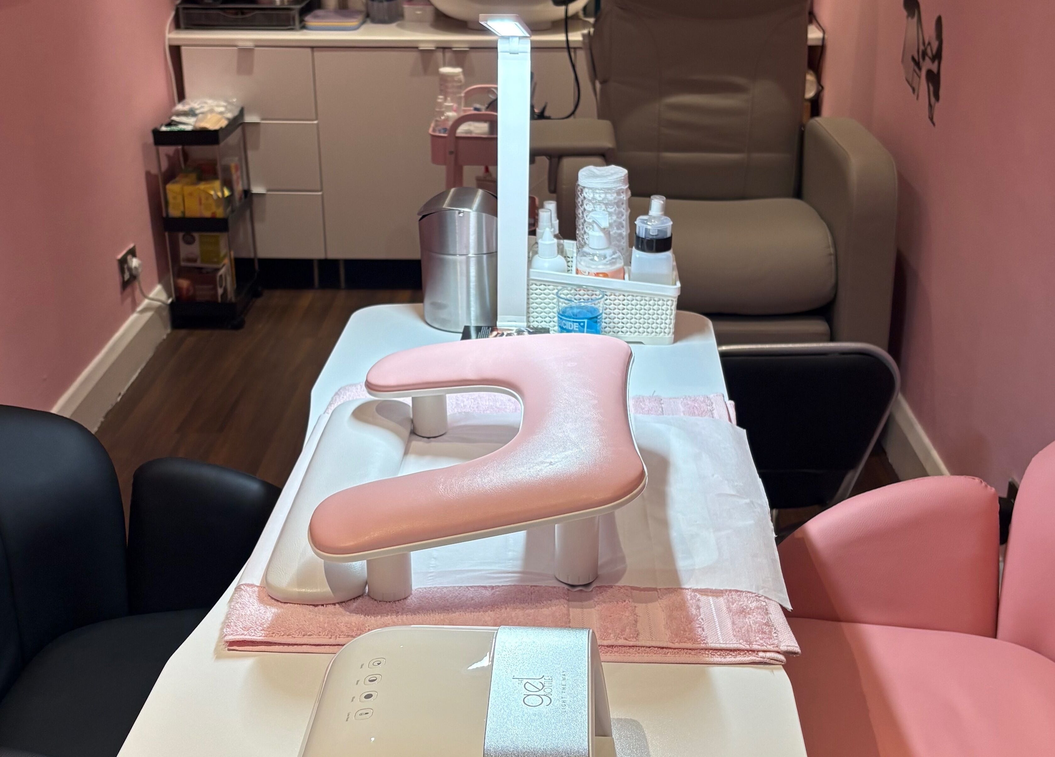 Inviting manicure station at Milita's Nails at Samantha James, Redhill, England, GB, featuring pink upholstery.