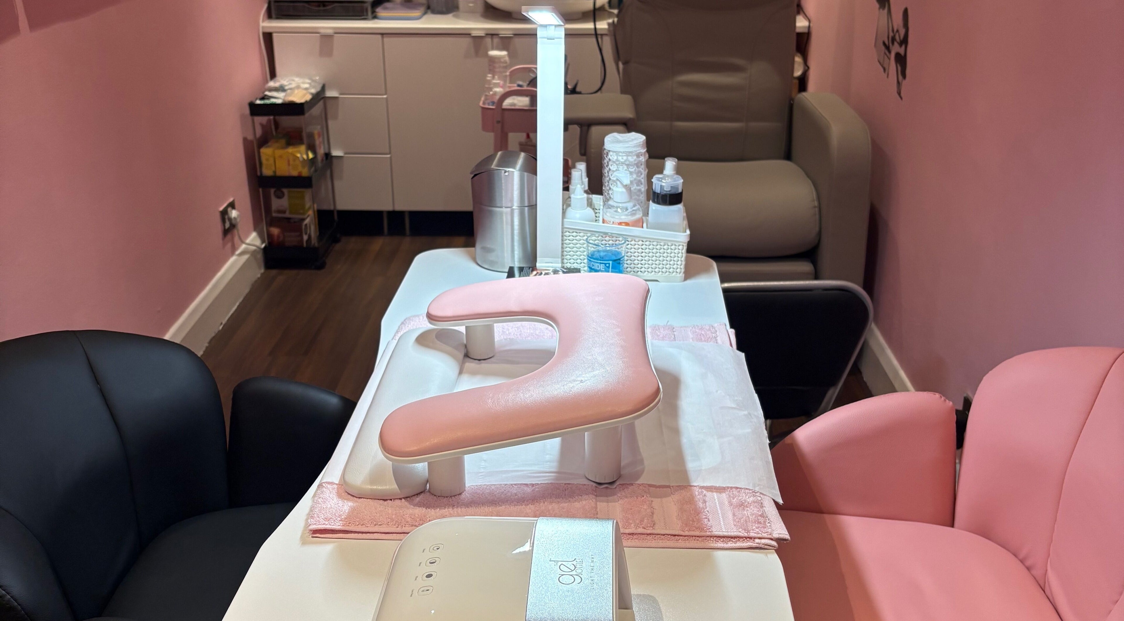 Inviting manicure station at Milita's Nails at Samantha James, Redhill, England, GB, featuring pink upholstery.