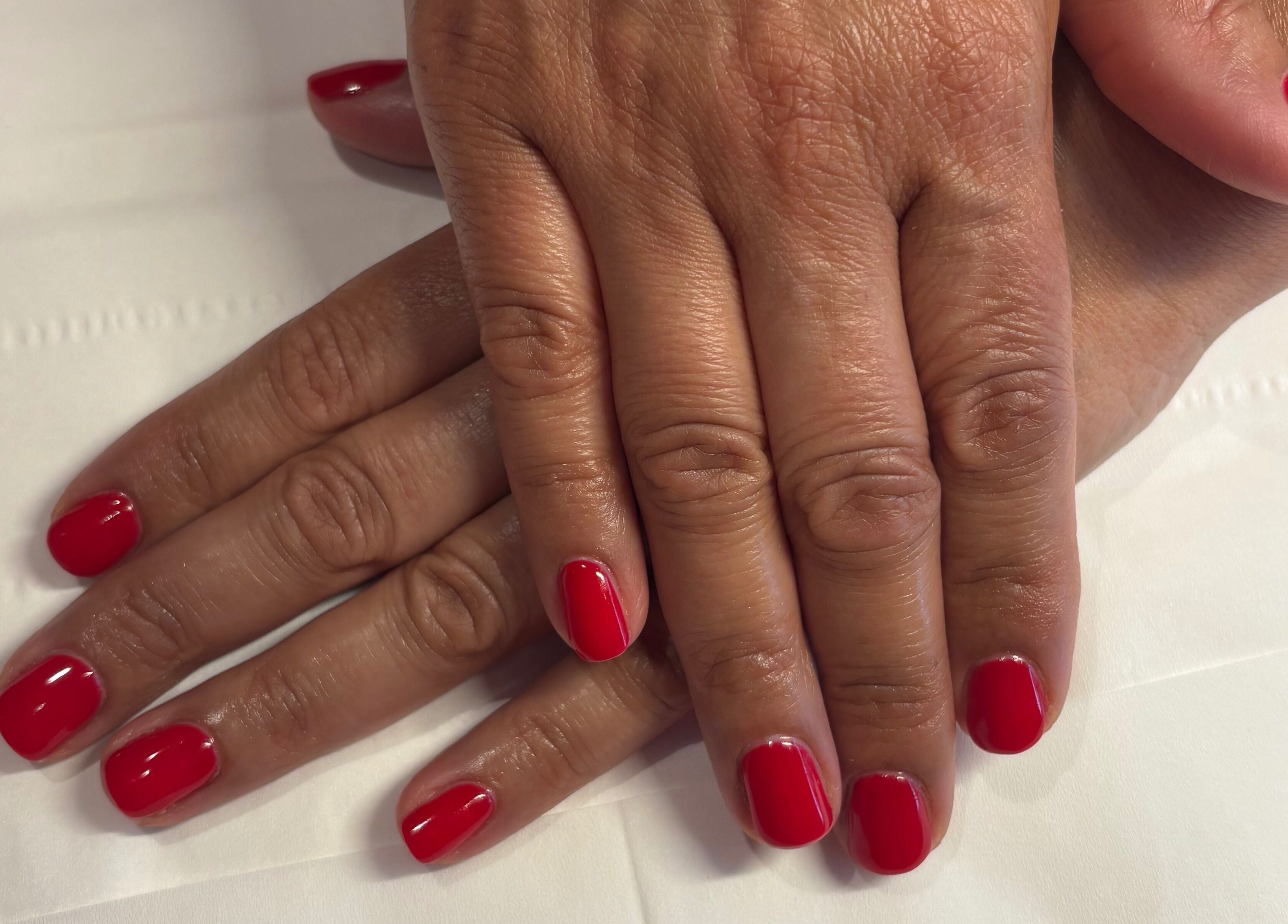 Vibrant red manicure at Milita's Nails at Samantha James, Redhill, England, GB.