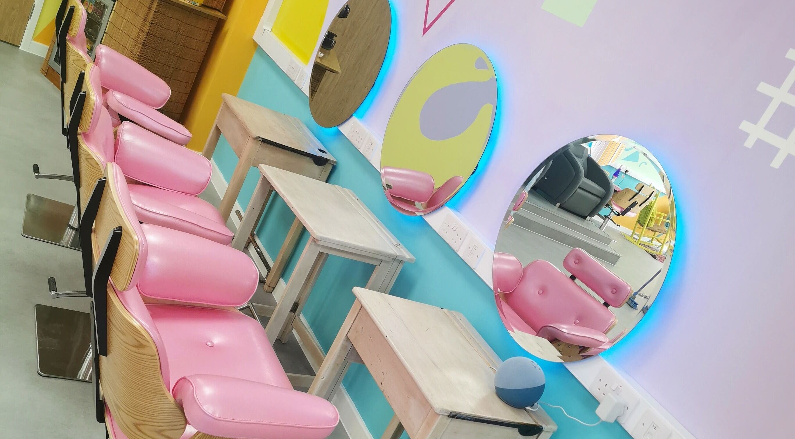 Bright salon chairs and mirrors at The Space, Southampton, England, GB, showcasing vibrant design and style.