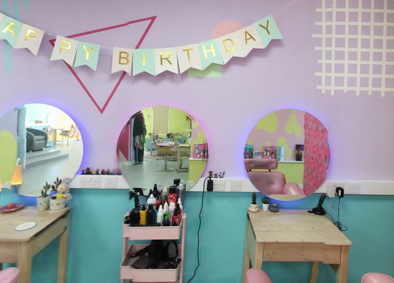 Vibrant beauty station with birthday decor at The Space, Southampton, England, GB. Stylish mirrors and tools.