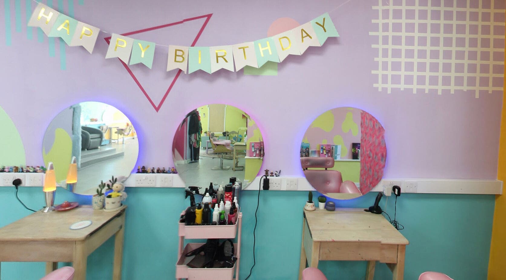 Vibrant beauty station with birthday decor at The Space, Southampton, England, GB. Stylish mirrors and tools.