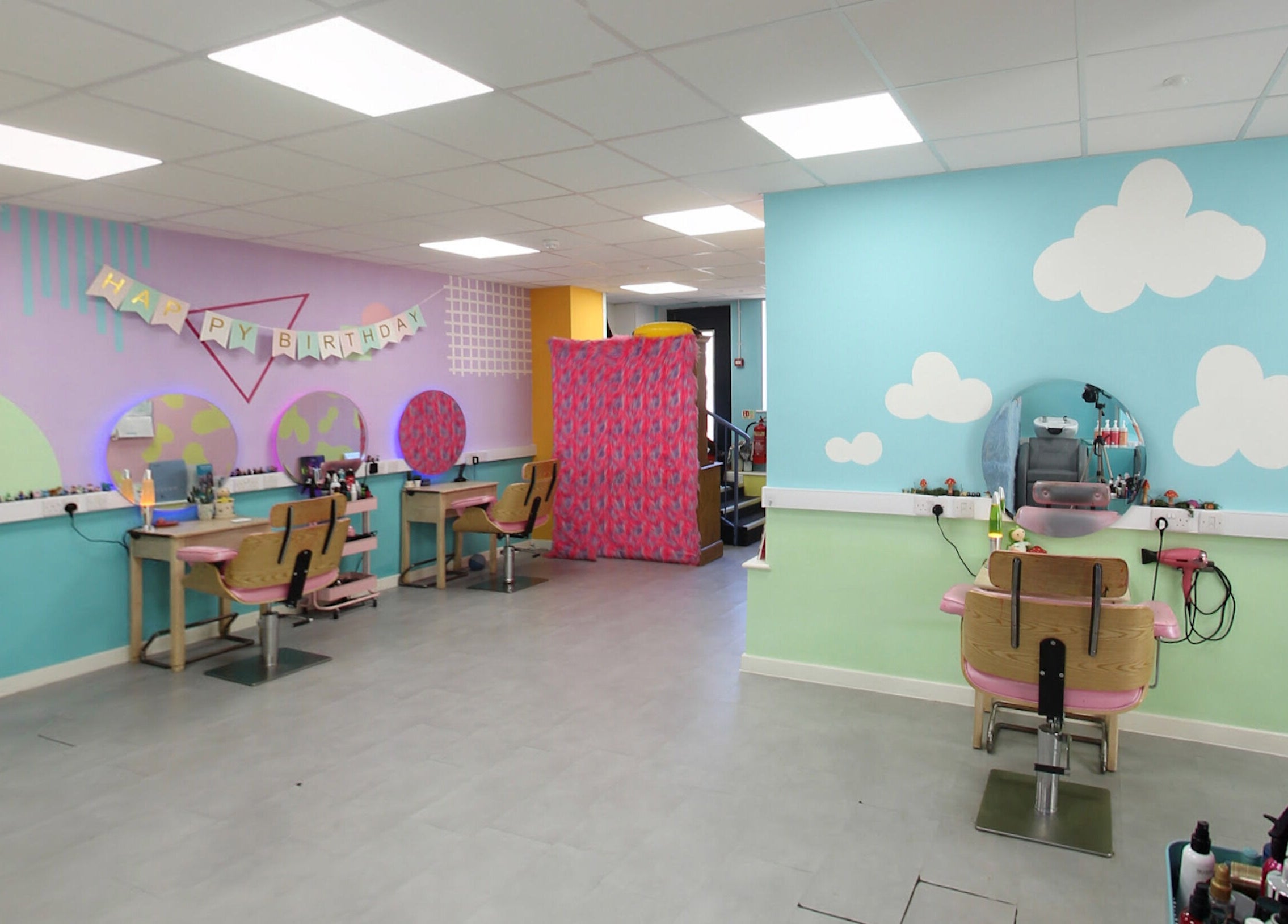 Vibrant salon interior at The Space, Southampton, England, GB with colorful decor and styling stations.