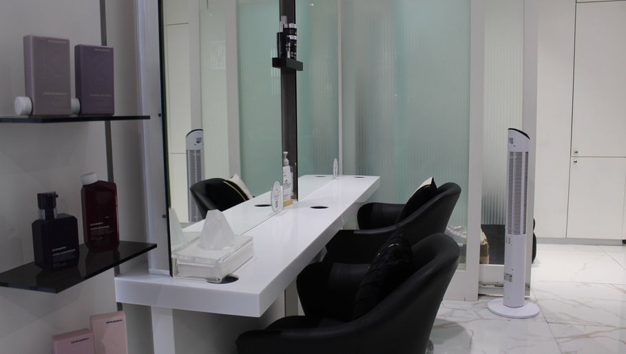 Chic styling station at Hair Signature Beauty Lounge, Dubai, AE, with sleek chairs and beauty products.