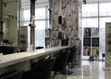 Modern salon interior at Hair Signature Beauty Lounge, Dubai, AE. Elegant design with stylish hair products displayed.